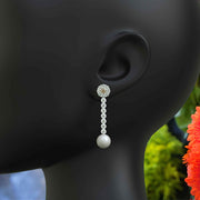 Classic Meets Sparkle: Pearl Drop Earrings with Moissanite Centerpiece.